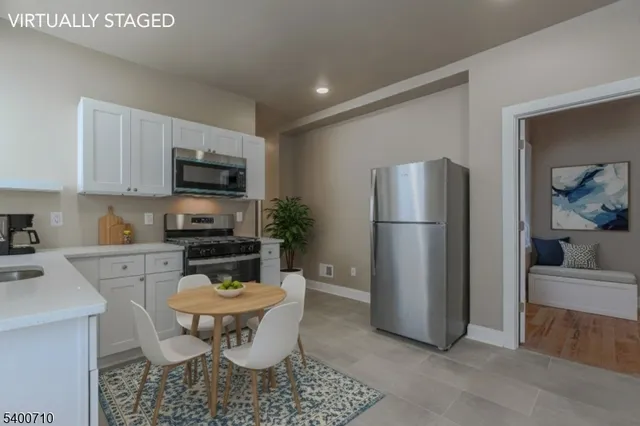 a kitchen with a refrigerator a stove a microwave and cabinets