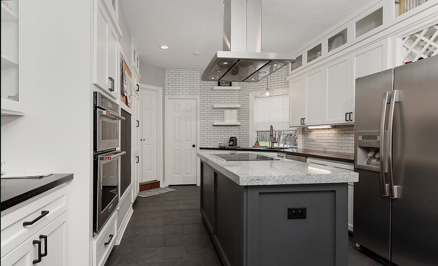 5 Indian Cedar Lane The Woodlands, TX 77380 - Photo 11 of 26 a kitchen with stainless steel appliances granite countertop a sink stove and refrigerator