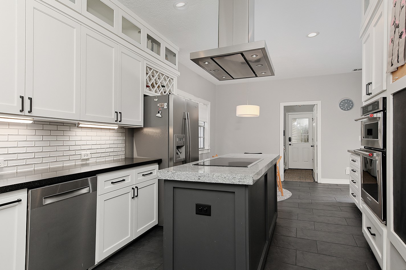5 Indian Cedar Lane The Woodlands, TX 77380 - Photo 12 of 26 a kitchen with granite countertop a sink a refrigerator a stove and cabinets