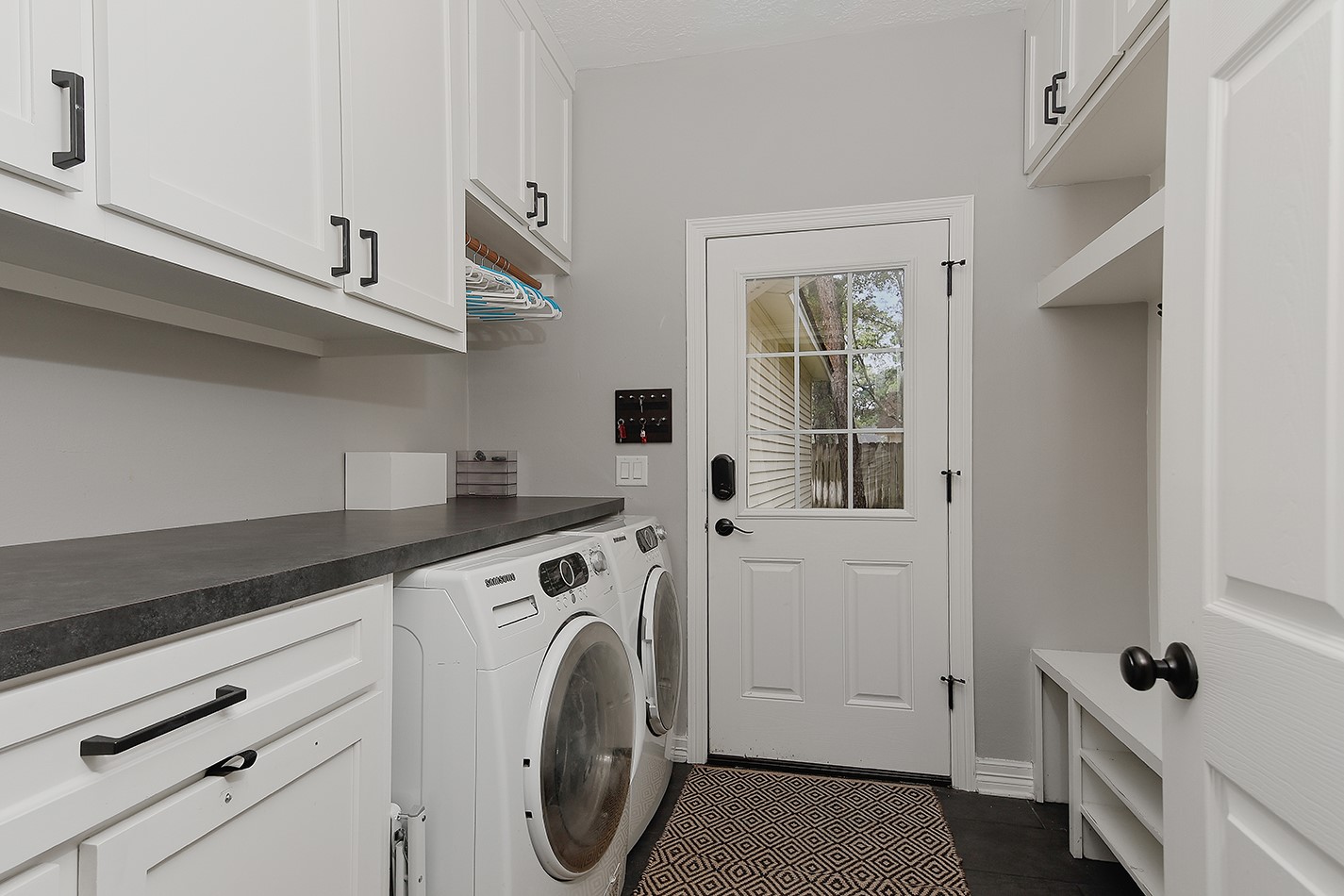 5 Indian Cedar Lane The Woodlands, TX 77380 - Photo 13 of 26 a utility room with cabinets washer and dryer