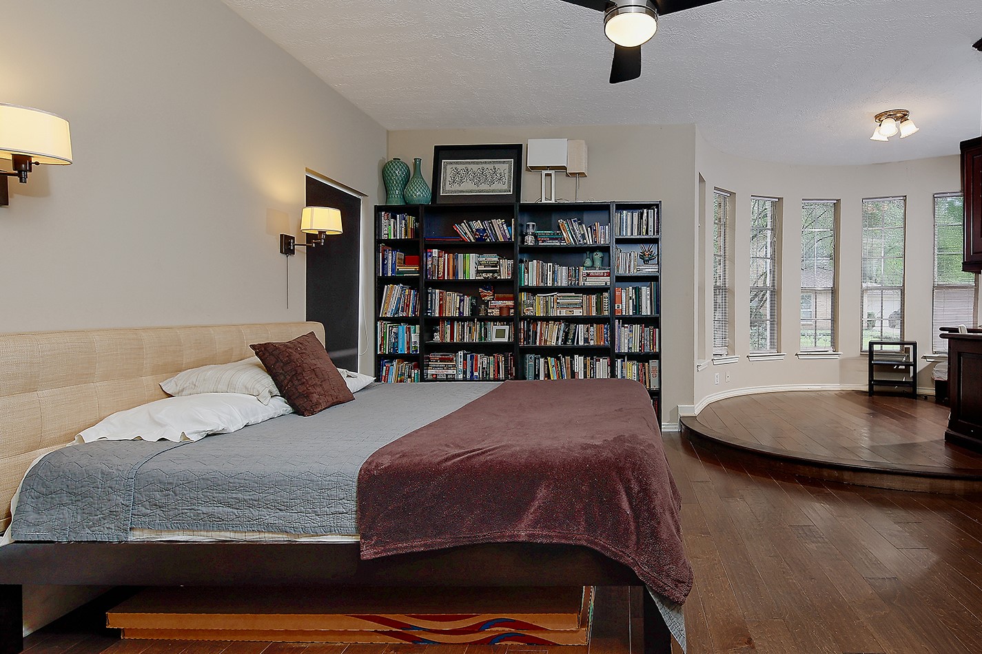5 Indian Cedar Lane The Woodlands, TX 77380 - Photo 14 of 26 a bedroom with a bed a book shelf and a window