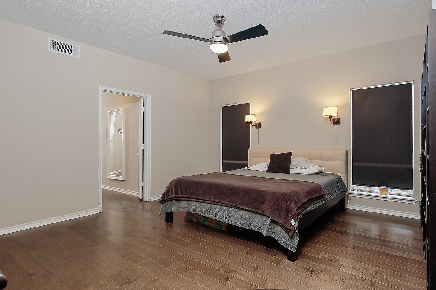 5 Indian Cedar Lane The Woodlands, TX 77380 - Photo 16 of 26 a bedroom with a bed and a walk in closet