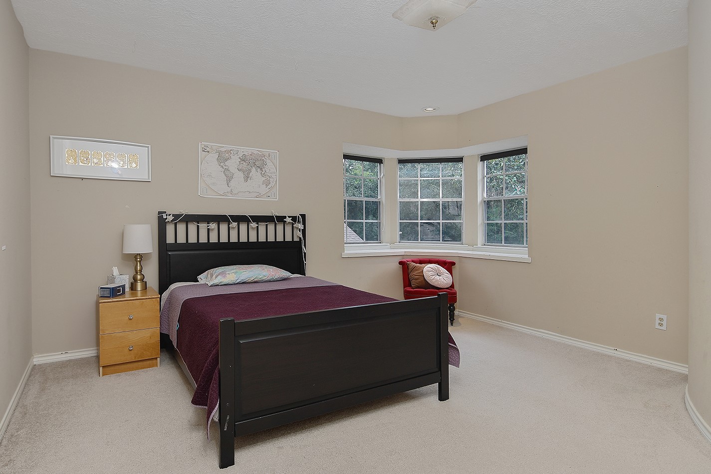 5 Indian Cedar Lane The Woodlands, TX 77380 - Photo 20 of 26 a bed sitting in a bedroom next to a window