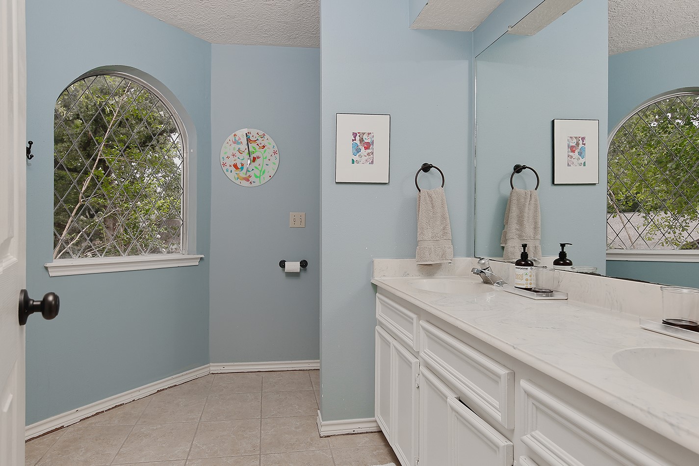 5 Indian Cedar Lane The Woodlands, TX 77380 - Photo 23 of 26 a bathroom with a sink and a mirror