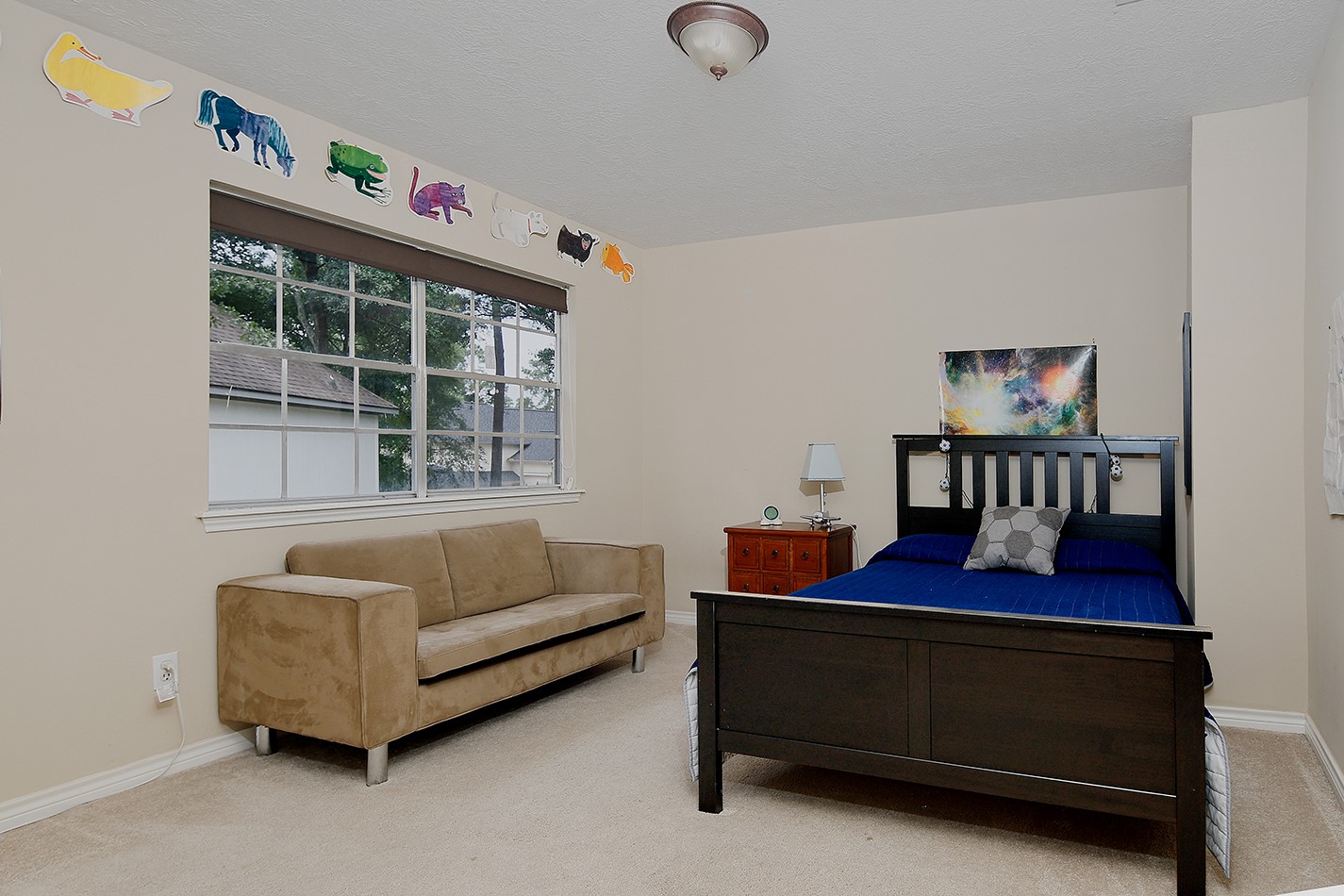 5 Indian Cedar Lane The Woodlands, TX 77380 - Photo 24 of 26 a bedroom with a bed and a window