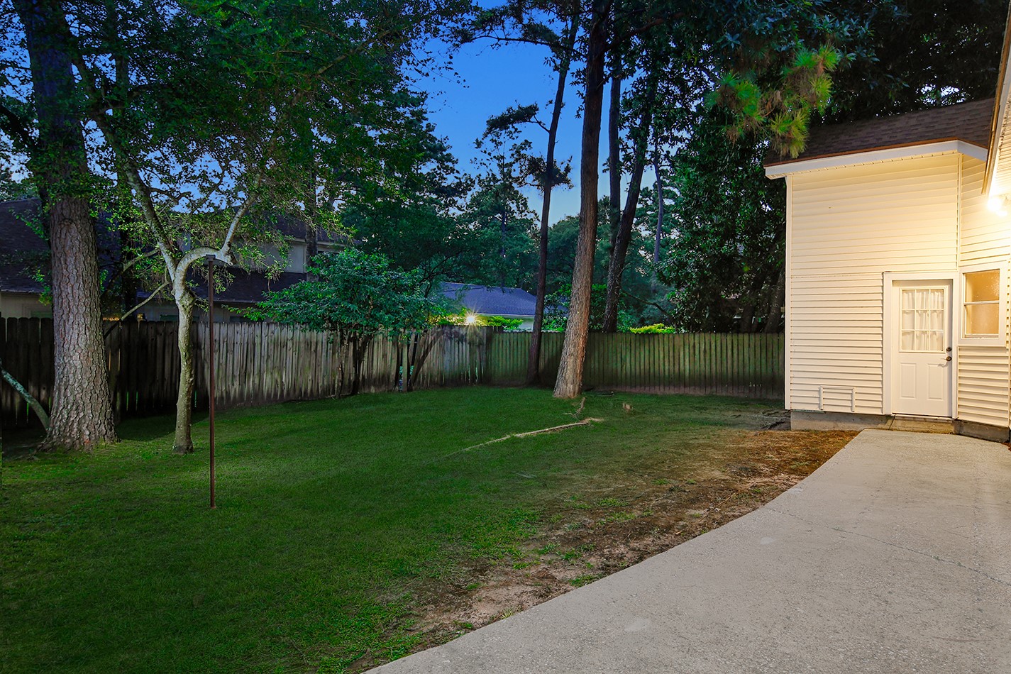 5 Indian Cedar Lane The Woodlands, TX 77380 - Photo 26 of 26 a backyard of a house with plants and large tree