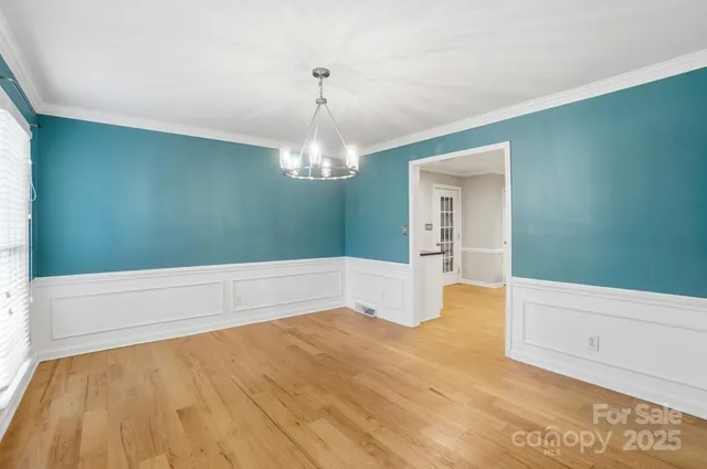 a spacious bathroom with a bathtub and chandelier