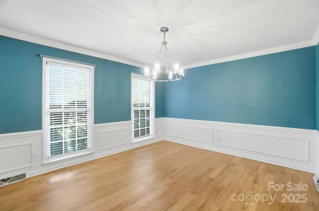 a view of wooden floor and windows in a room