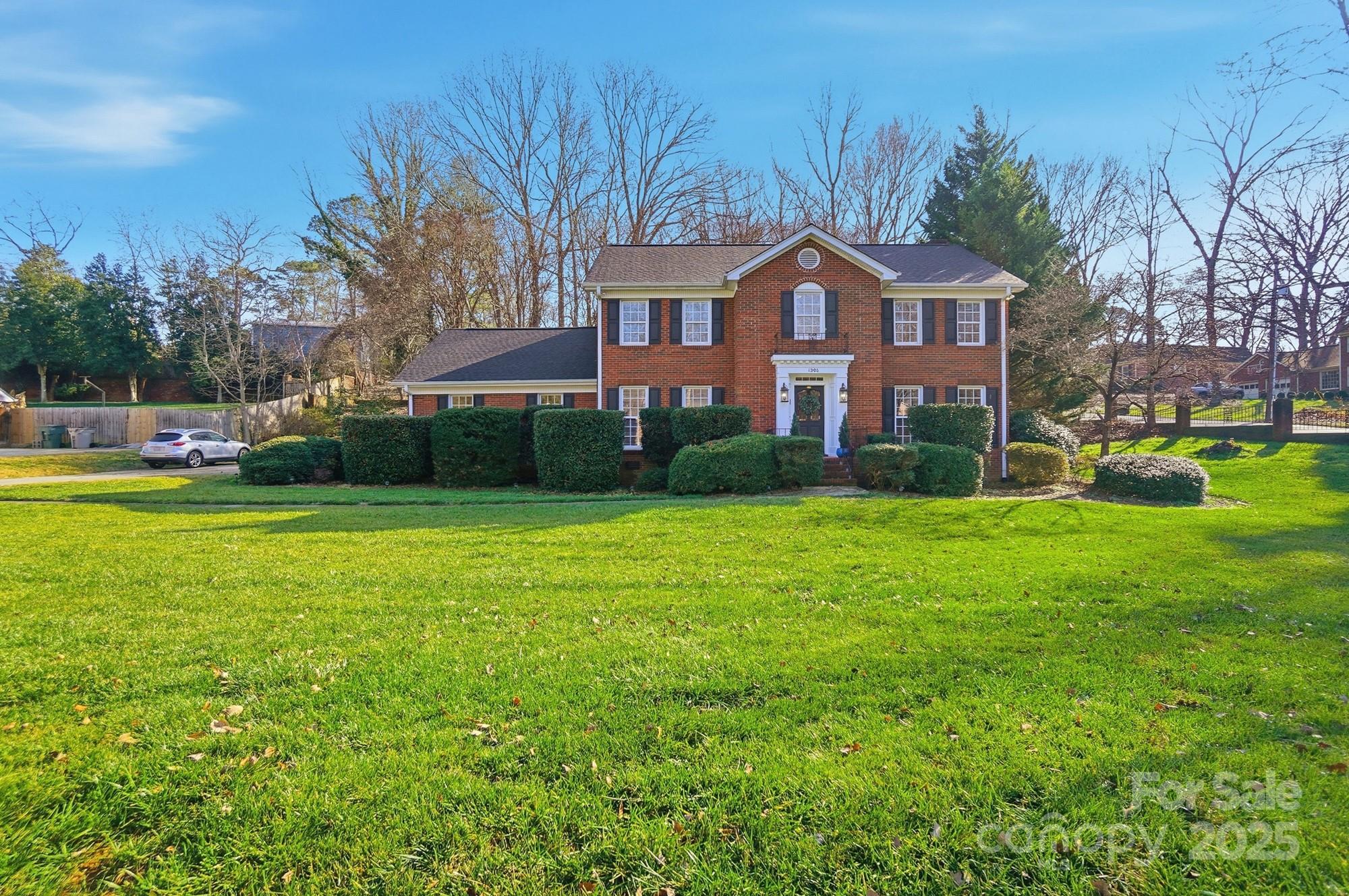 1308 Dumbarton Road Gastonia, NC 28054 - Photo 2 of 48 a front view of a house with garden and trees