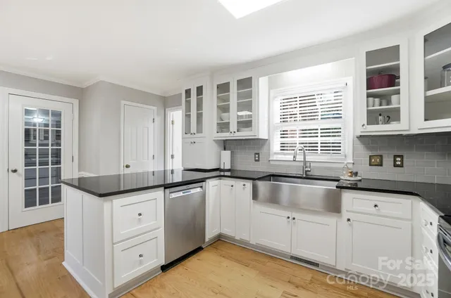 a kitchen with granite countertop a sink and cabinets