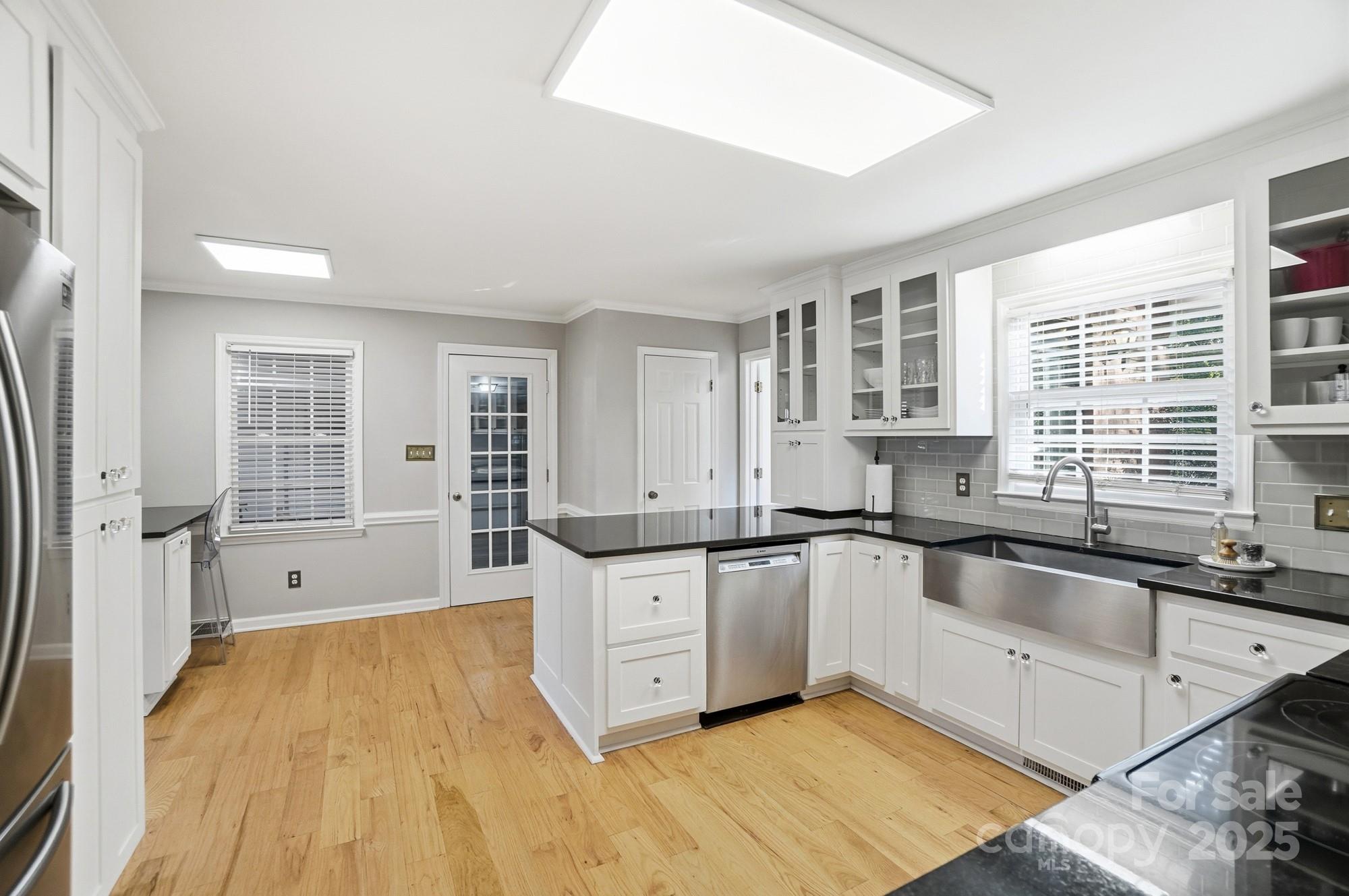 1308 Dumbarton Road Gastonia, NC 28054 - Photo 23 of 48 a large kitchen with granite countertop a sink and cabinets