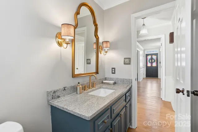 a bathroom with a granite countertop sink and a mirror