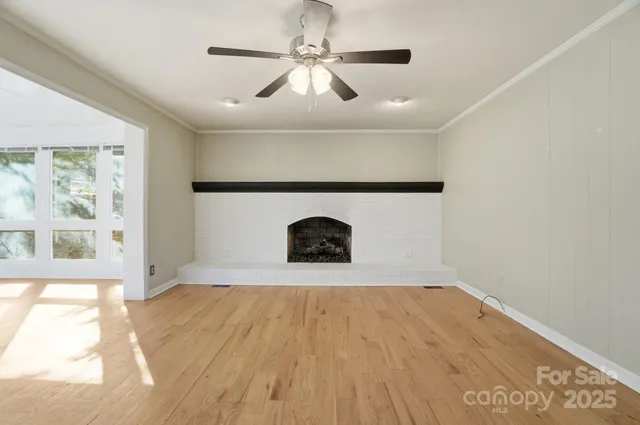 a view of empty room with window and fireplace