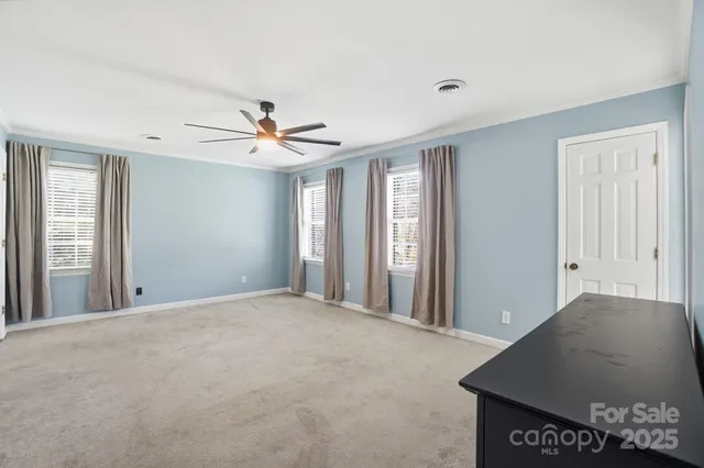 a view of a livingroom with a ceiling fan and window