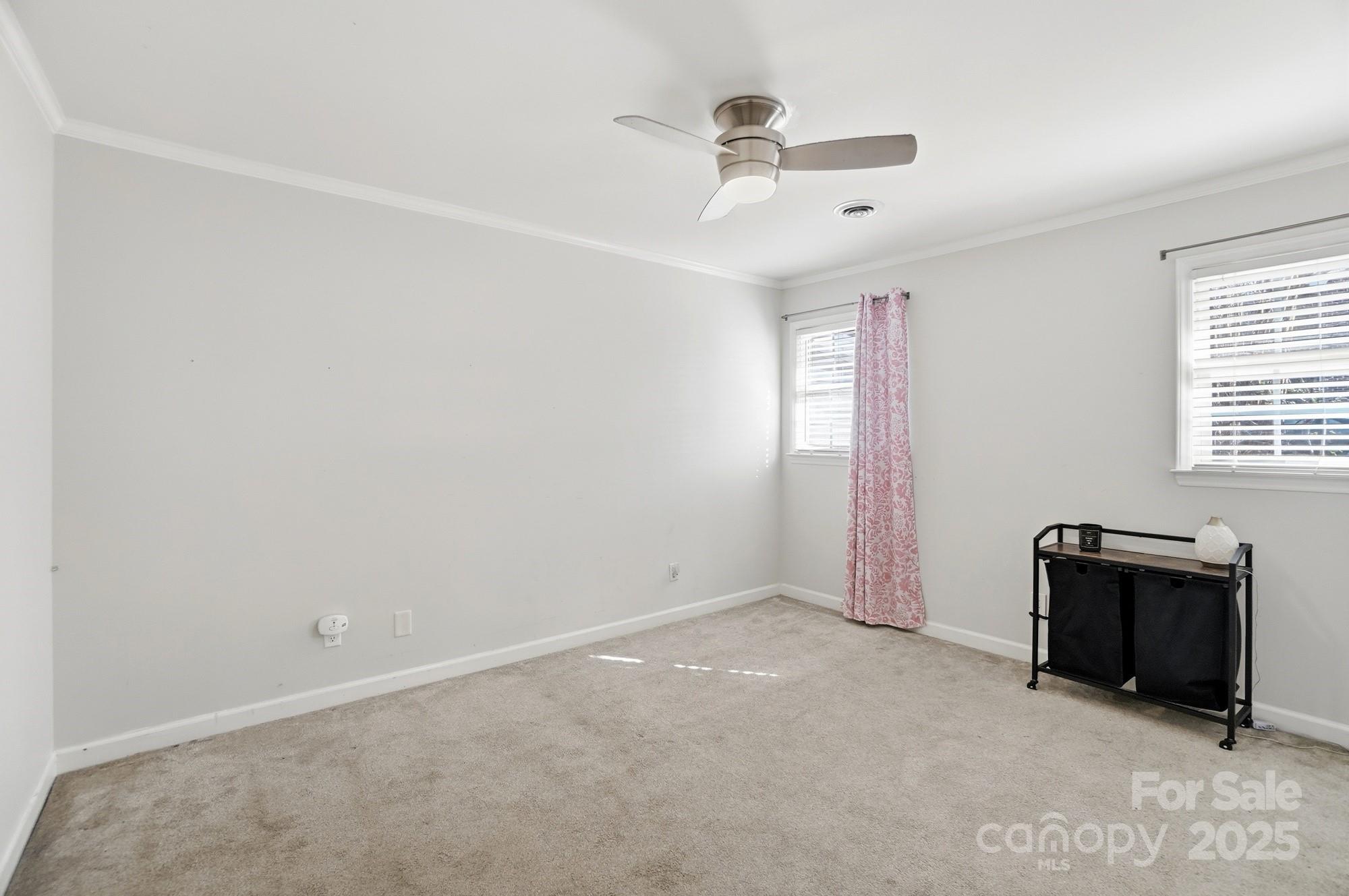 1308 Dumbarton Road Gastonia, NC 28054 - Photo 41 of 48 an empty room with a ceiling fan and windows