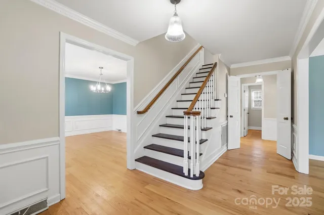 a view of entryway and hall with wooden floor