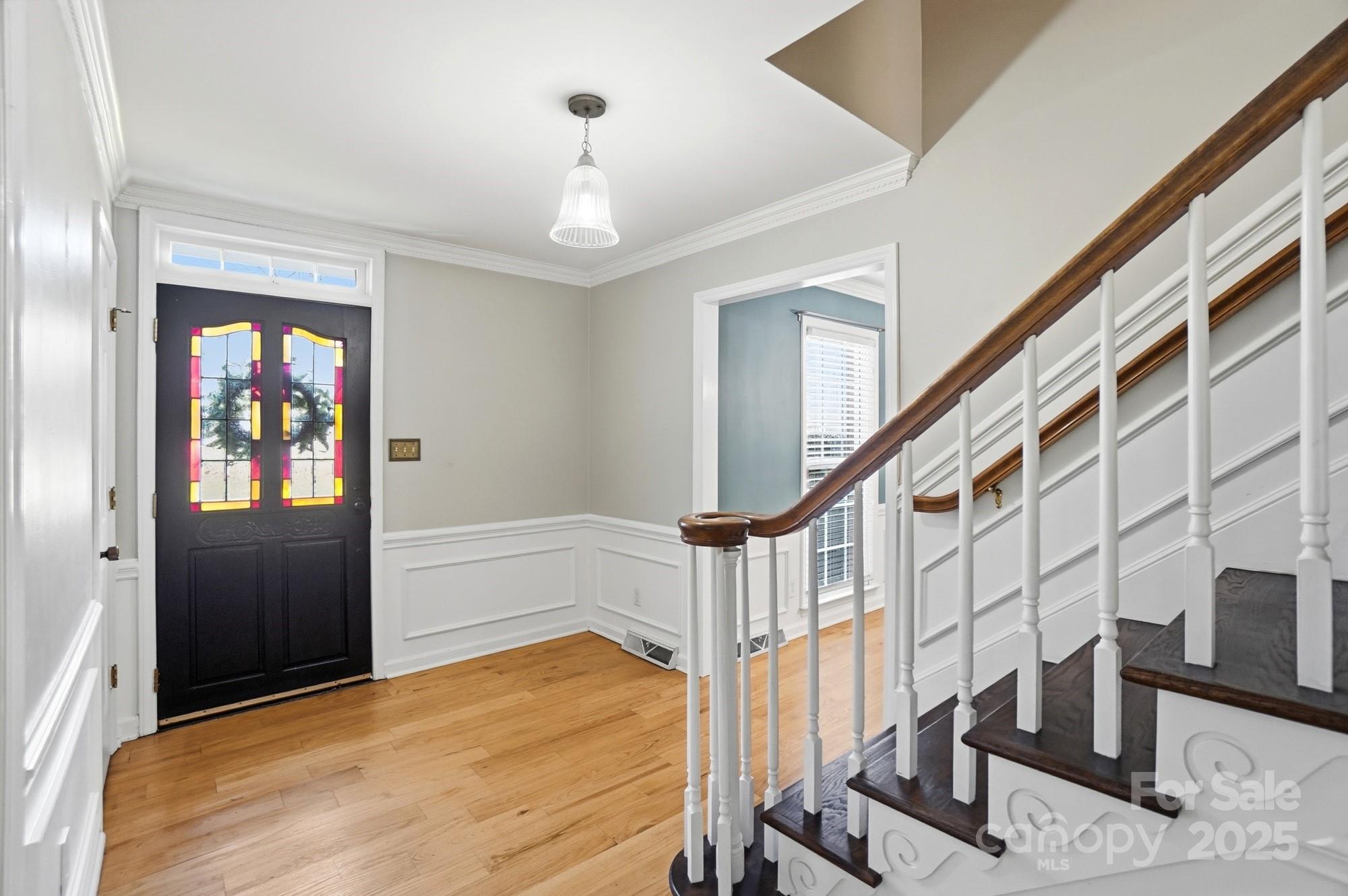 1308 Dumbarton Road Gastonia, NC 28054 - Photo 6 of 48 a view of entryway with wooden floor and stairs