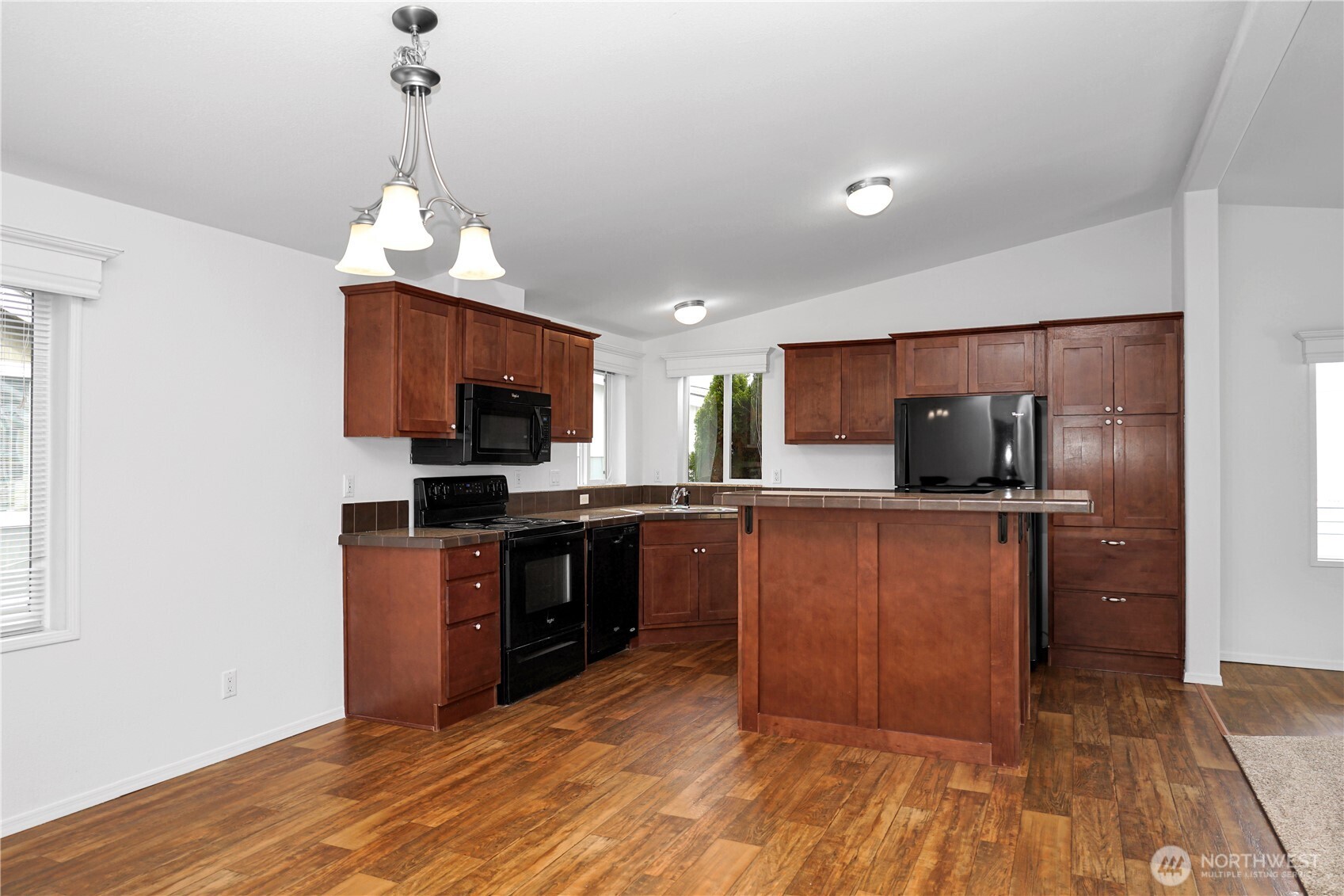 15231 Pine Drive Renton, WA 98058 - Photo 11 of 29 a kitchen with stainless steel appliances granite countertop a refrigerator oven a sink dishwasher and a refrigerator with wooden floor
