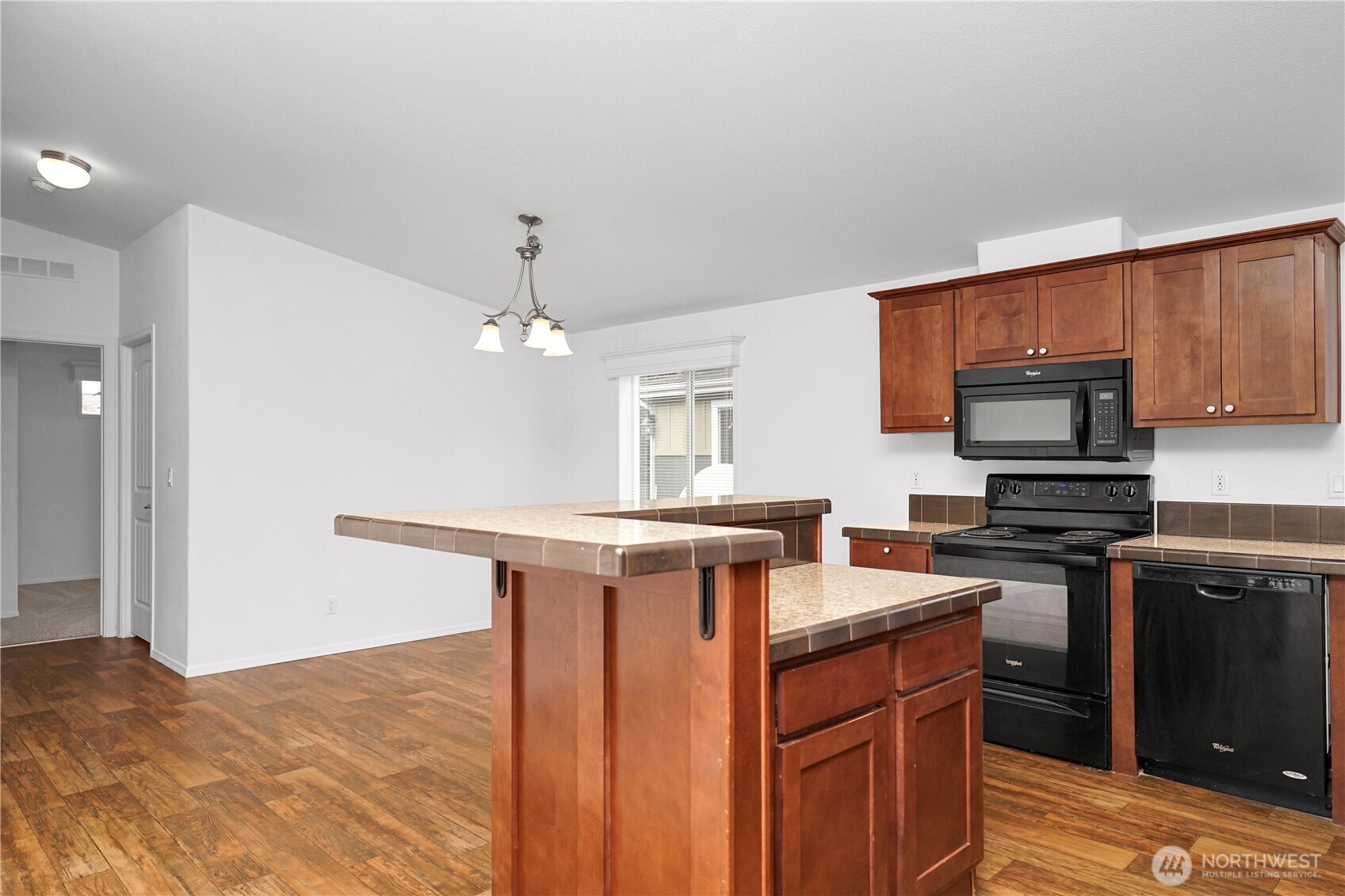 15231 Pine Drive Renton, WA 98058 - Photo 12 of 29 a kitchen with stainless steel appliances granite countertop a stove refrigerator and microwave