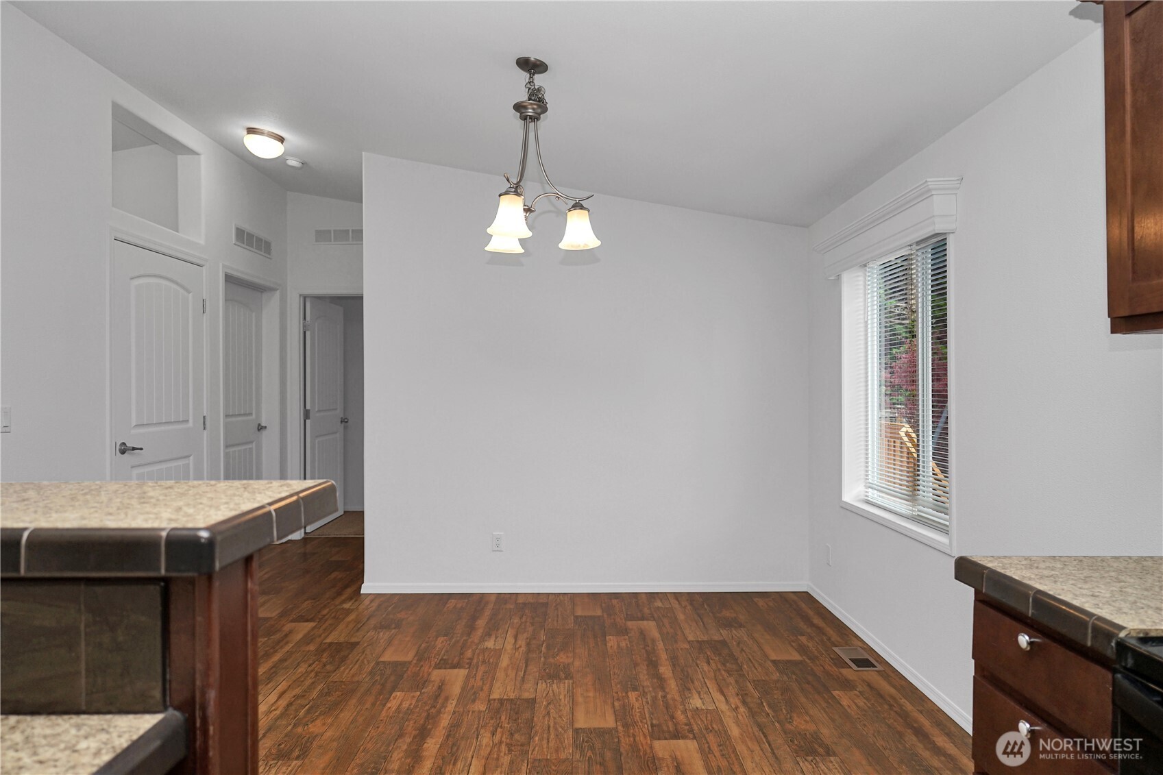 15231 Pine Drive Renton, WA 98058 - Photo 13 of 29 a view of a room with wooden floor and chandelier