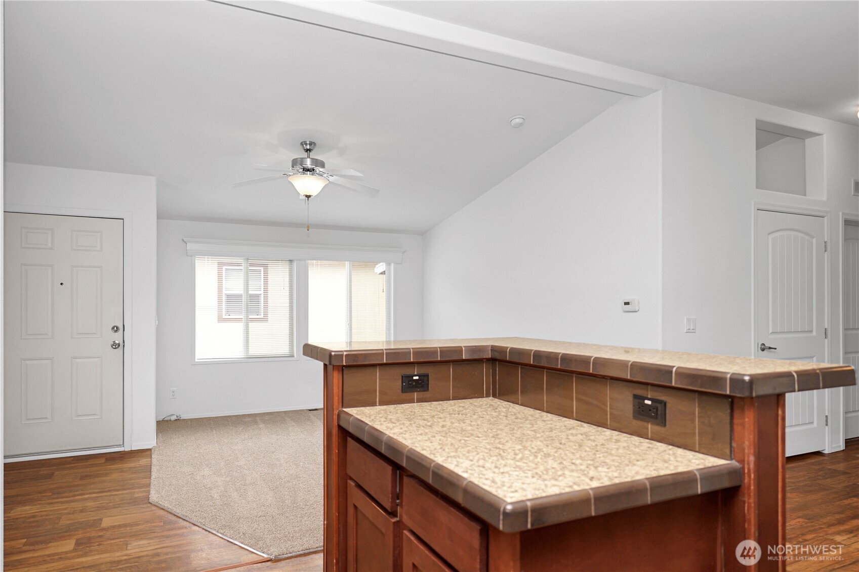 15231 Pine Drive Renton, WA 98058 - Photo 3 of 29 a kitchen with a fridge and chandelier