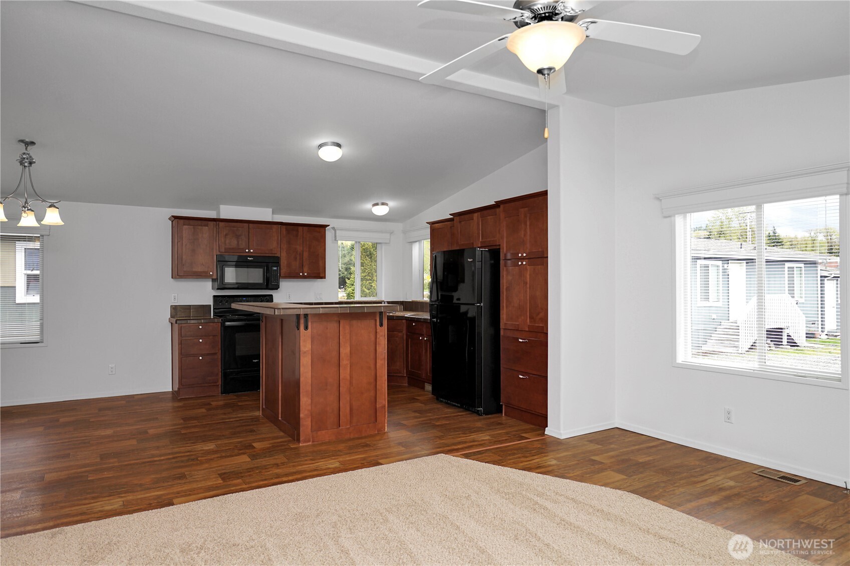 15231 Pine Drive Renton, WA 98058 - Photo 5 of 29 a kitchen with kitchen island a counter top space appliances and a window