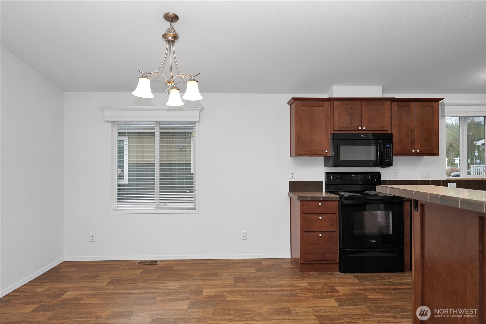 15231 Pine Drive Renton, WA 98058 - Photo 7 of 29 a kitchen with stainless steel appliances granite countertop a stove and a refrigerator