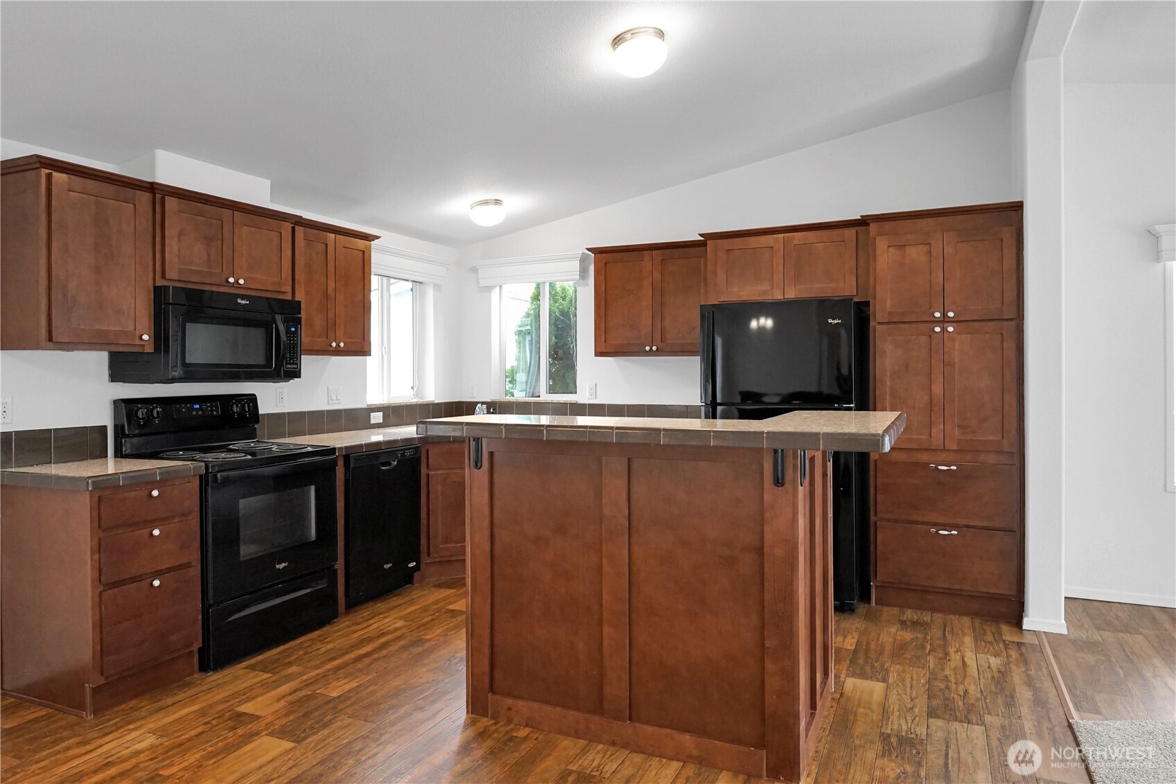 15231 Pine Drive Renton, WA 98058 - Photo 8 of 29 a kitchen with wooden cabinets a sink and a stove