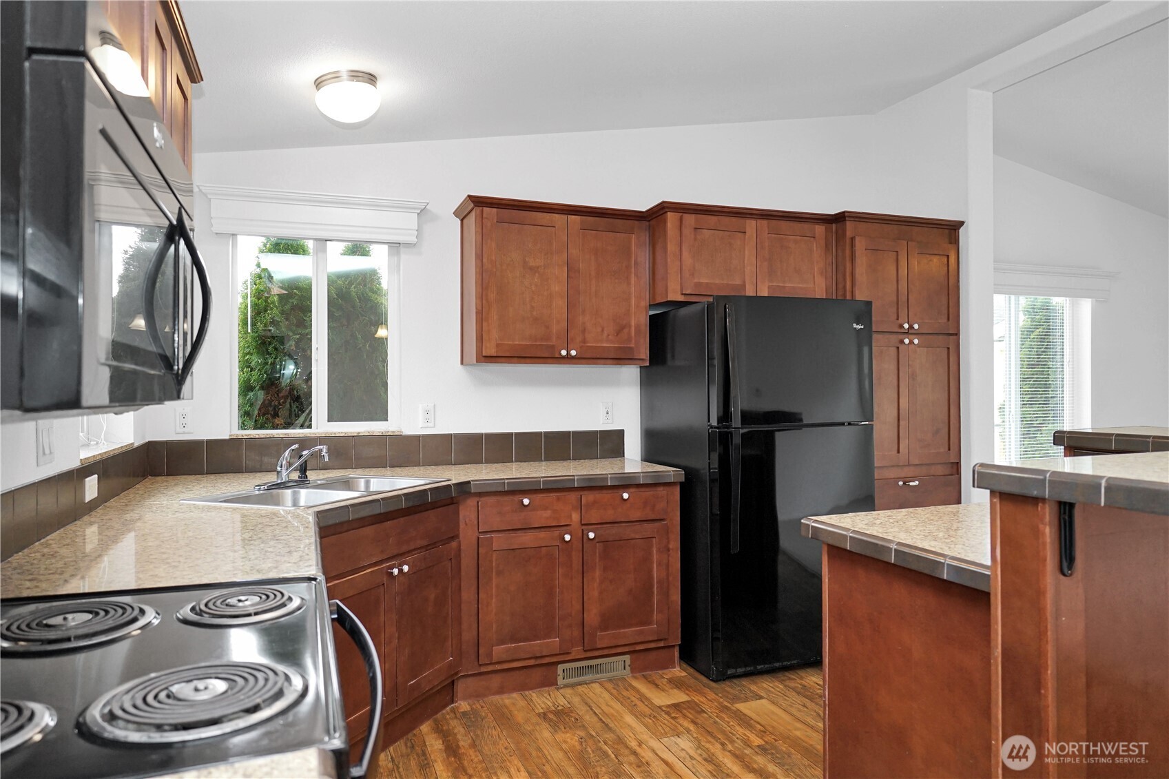 15231 Pine Drive Renton, WA 98058 - Photo 9 of 29 a kitchen with a sink a refrigerator and a stove