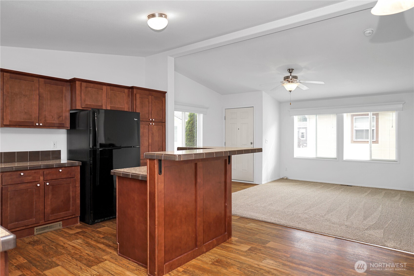 15231 Pine Drive Renton, WA 98058 - Photo 10 of 29 a kitchen with granite countertop cabinets and refrigerator