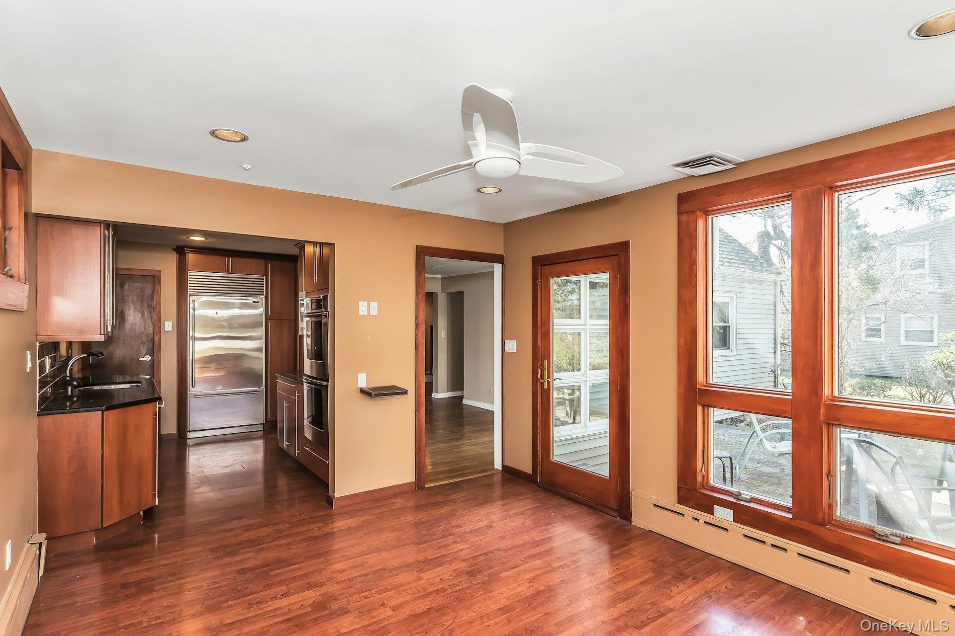 11 Rockhill Road East Hills, NY 11577 - Photo 14 of 27 a view of a livingroom with wooden floor and a ceiling fan
