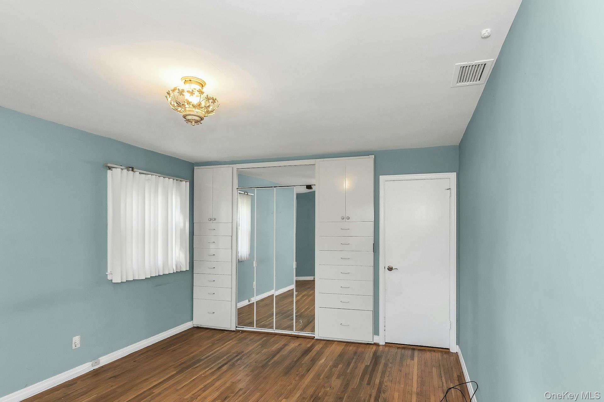 11 Rockhill Road East Hills, NY 11577 - Photo 18 of 27 wooden floor in an empty room with a window