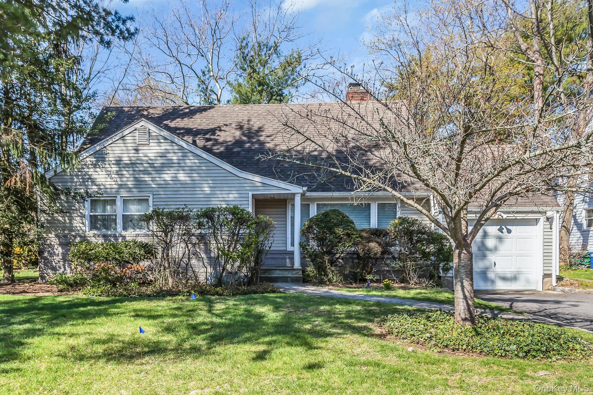 11 Rockhill Road East Hills, NY 11577 - Photo 2 of 27 a backyard of a house with potted plants and large tree