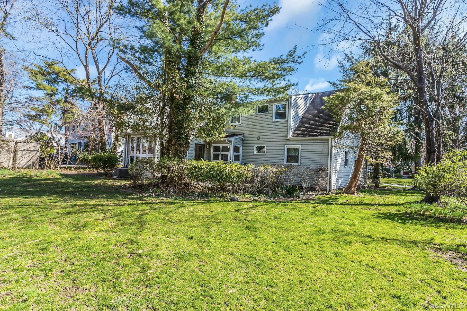 11 Rockhill Road East Hills, NY 11577 - Photo 25 of 27 a front view of a house with a yard