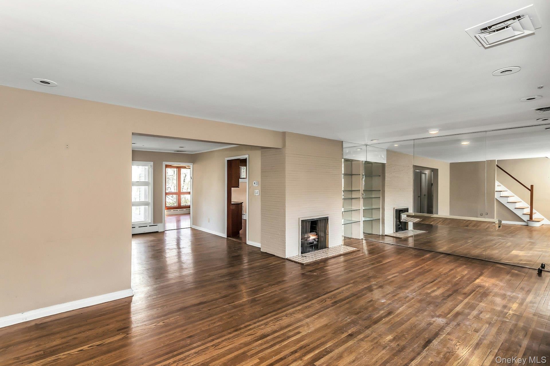 11 Rockhill Road East Hills, NY 11577 - Photo 4 of 27 a view of empty room with wooden floor and fireplace