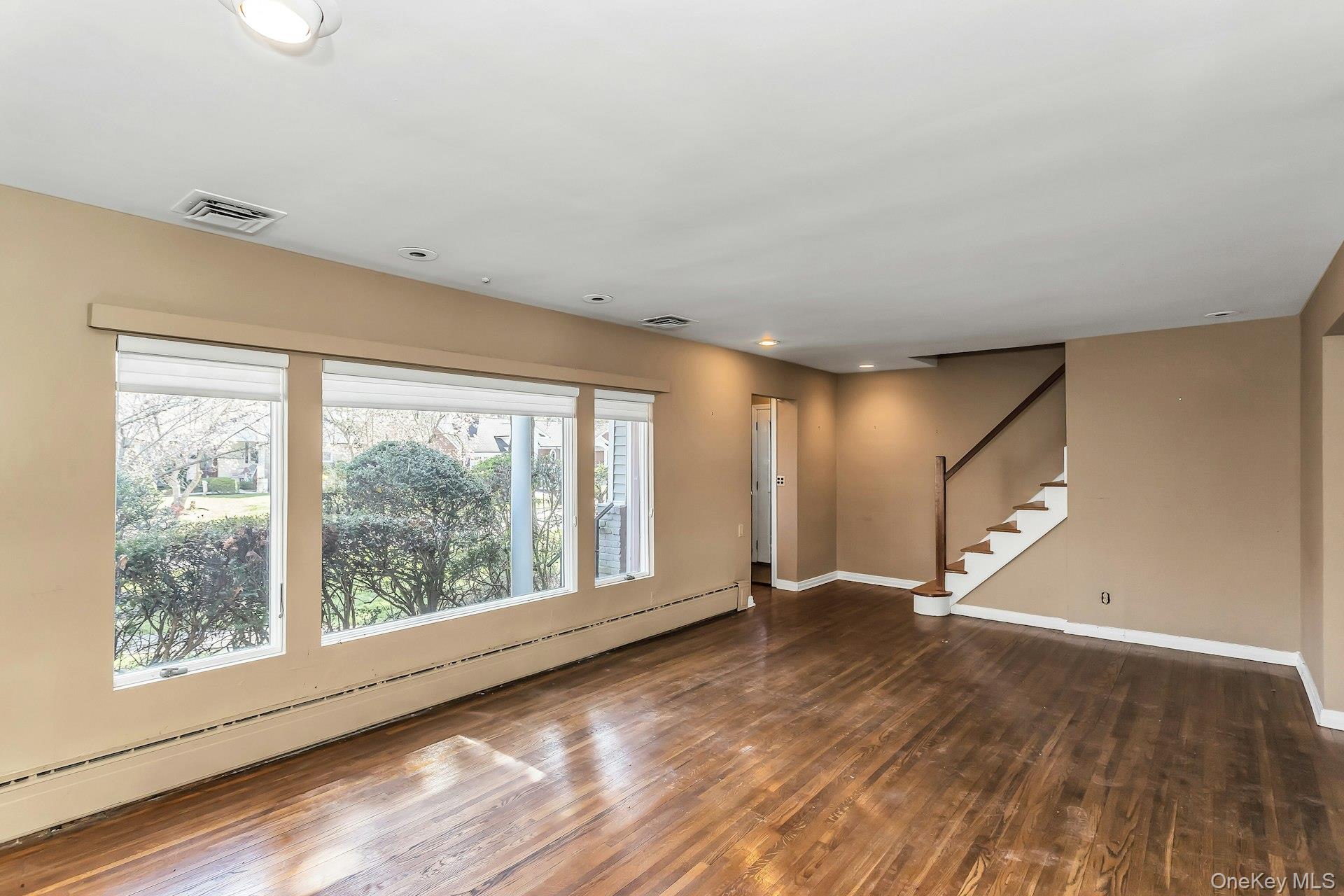11 Rockhill Road East Hills, NY 11577 - Photo 6 of 27 a view of an empty room with wooden floor and a window