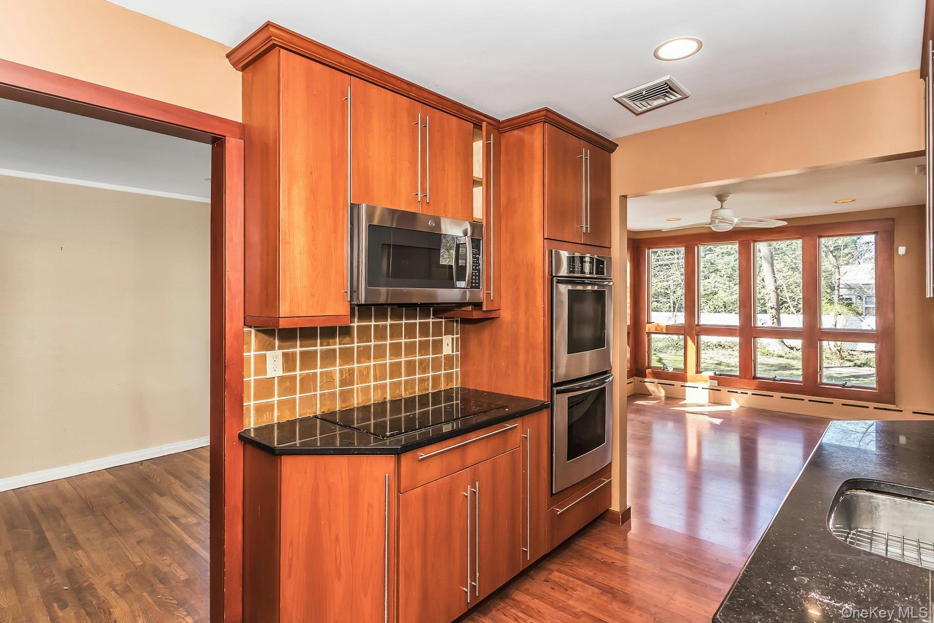 11 Rockhill Road East Hills, NY 11577 - Photo 10 of 27 a kitchen with stainless steel appliances granite countertop a refrigerator a stove and a wooden cabinets