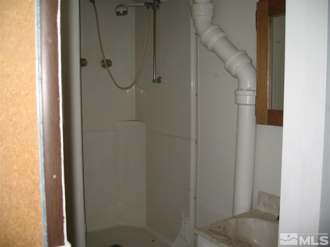 1220 Forest Street Reno, NV 89509 - Photo 22 of 25 a bathroom with a glass shower door