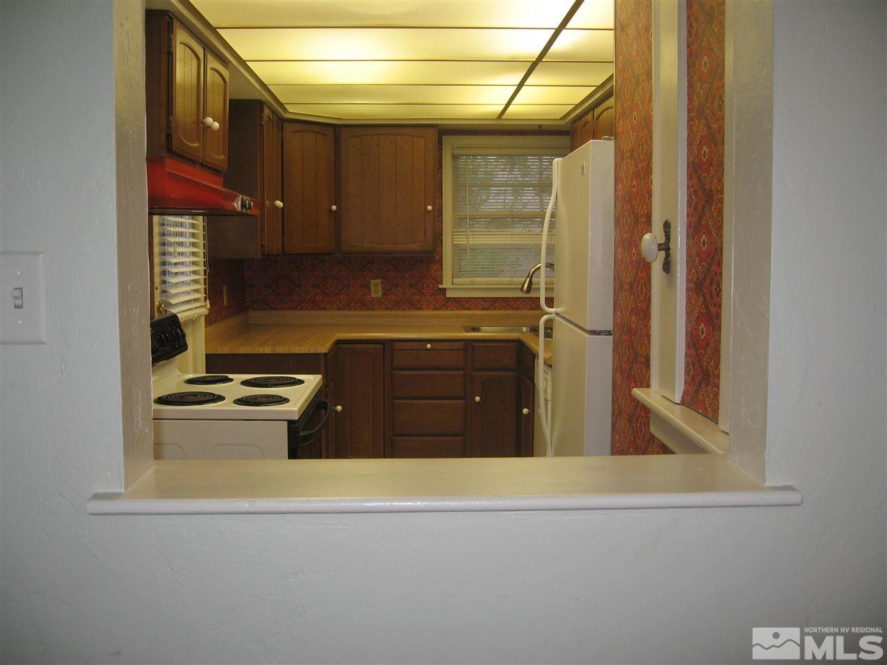 1220 Forest Street Reno, NV 89509 - Photo 7 of 25 a kitchen with a sink a stove and a refrigerator