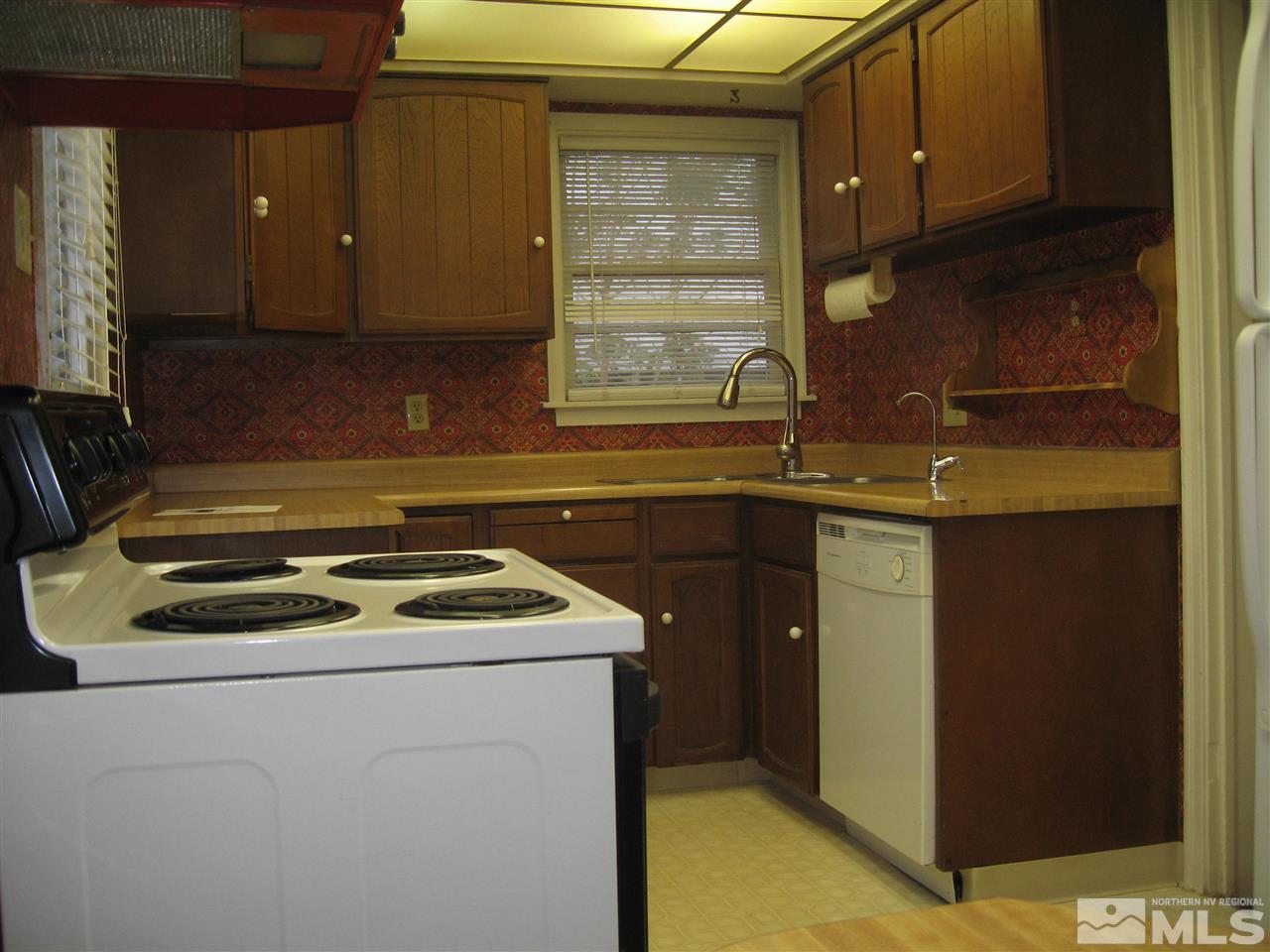 1220 Forest Street Reno, NV 89509 - Photo 8 of 25 a kitchen with a sink stove and cabinets