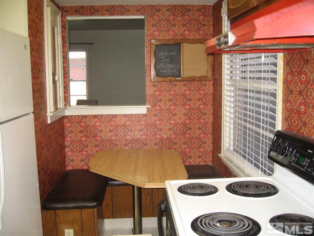 1220 Forest Street Reno, NV 89509 - Photo 9 of 25 a kitchen with a table and a stove top oven