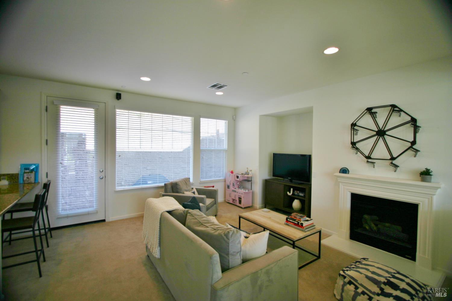 36 Rowe Ranch Drive Novato, CA 94949 - Photo 6 of 12 a living room with furniture a fireplace and a flat screen tv