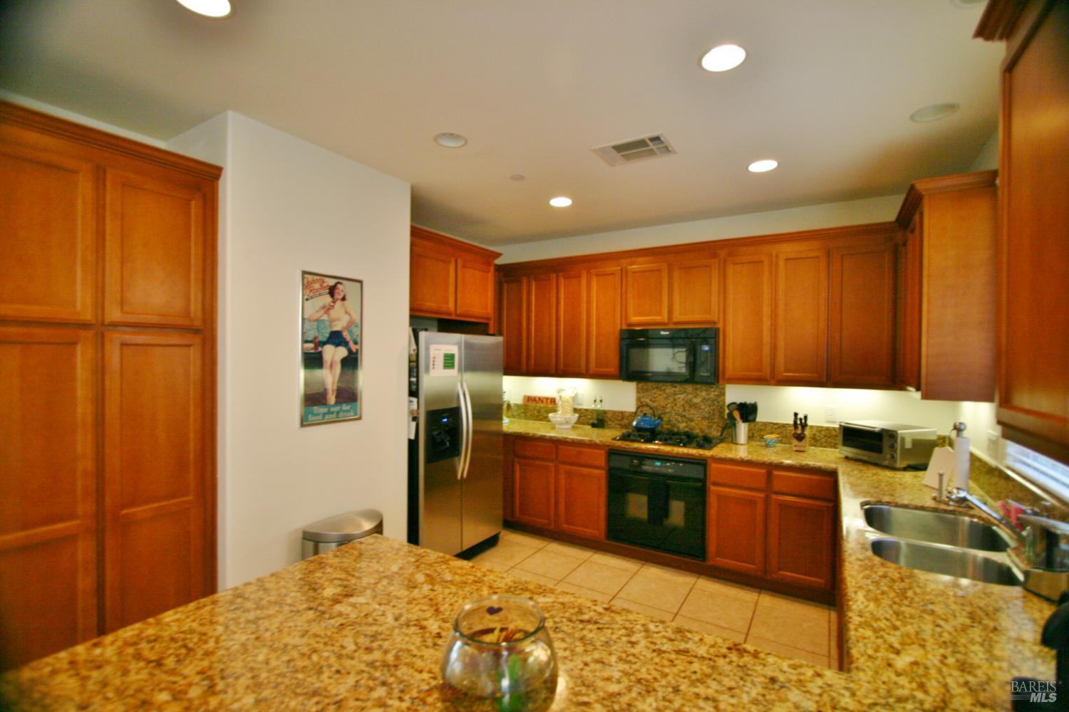 36 Rowe Ranch Drive Novato, CA 94949 - Photo 8 of 12 a kitchen with stainless steel appliances granite countertop sink stove and refrigerator