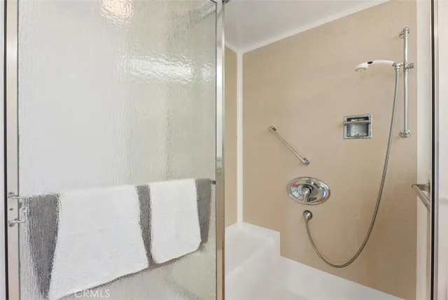 a bathroom with a granite countertop sink toilet a large mirror a shower and bathtub