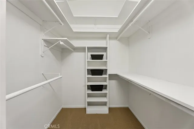 a bedroom with a bed and a lamp