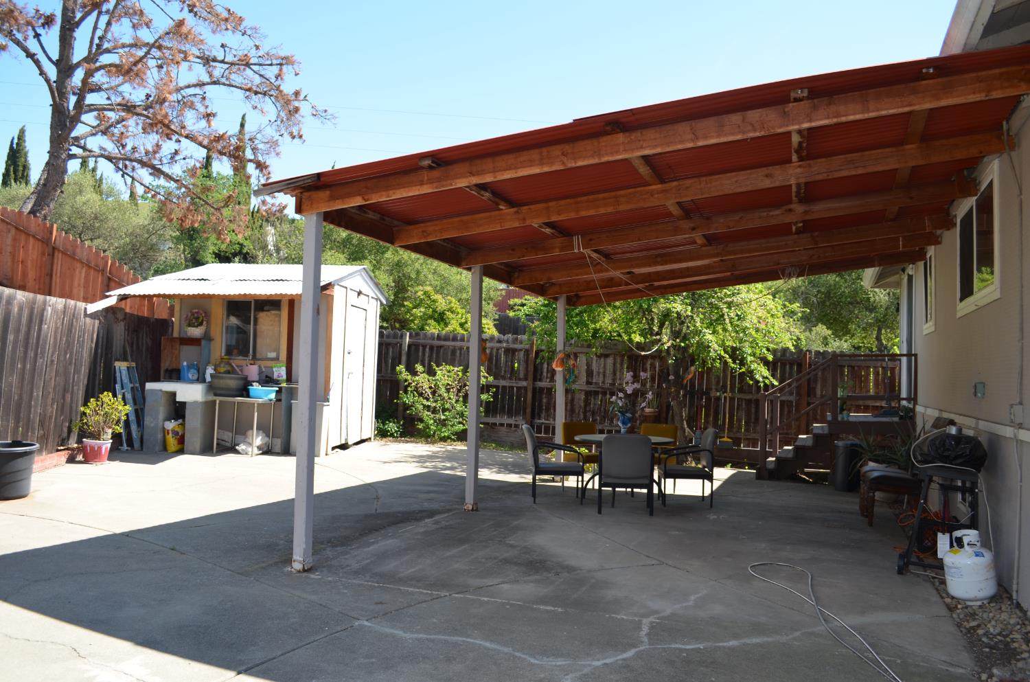 208 Appian Way Union City, CA 94587 - Photo 11 of 38 a view of a patio with a table and chairs under an umbrella with a large tree