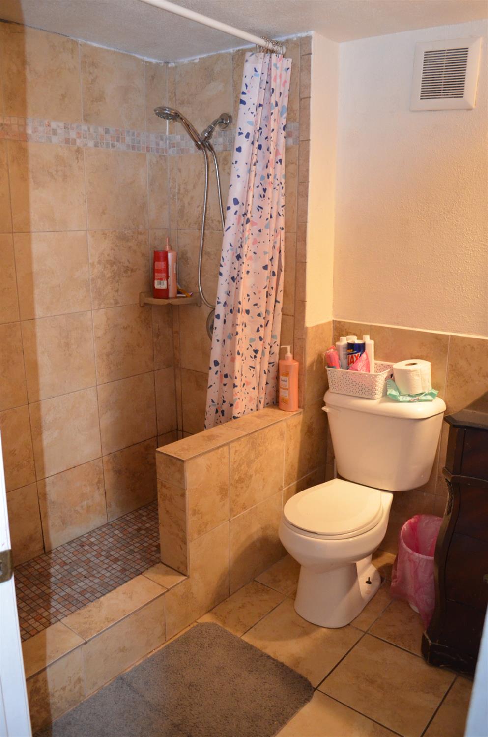 208 Appian Way Union City, CA 94587 - Photo 36 of 38 a white toilet sitting next to a shower curtain
