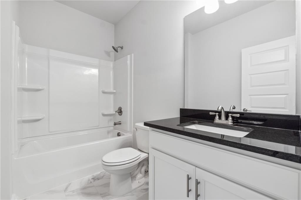 2546 Harbor Ridge Pass, Unit 341 Gainesville, GA 30507 - Photo 21 of 41 a bathroom with a granite countertop sink mirror toilet and bathtub