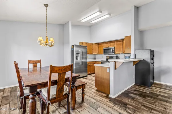 a kitchen with stainless steel appliances a stove microwave and sink
