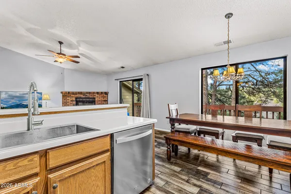 a view of a dining room with furniture a chandelier and wooden floor